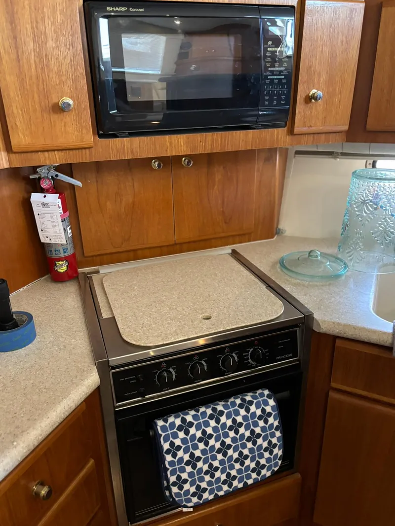 Slide: The Image of Kitchen area in a 2000 Carver 406 Aft Cabin Motor Yacht with microwave and oven. - 30