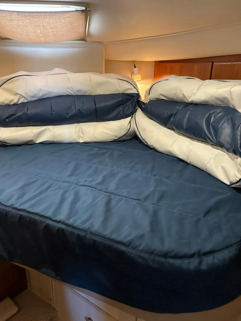 Slide: The Image of Interior cabin of 2000 Carver 406 Aft Cabin Motor Yacht with blue bedding. - 31