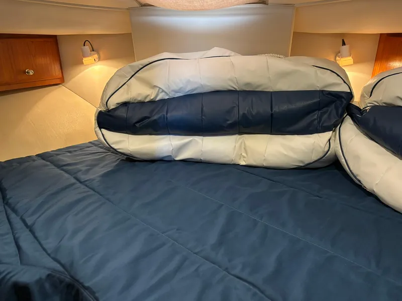 Slide: The Image of Cozy cabin interior of 2000 Carver 406 Aft Cabin Motor Yacht with blue bedding. - 32
