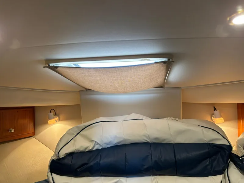 Slide: The Image of Interior cabin of 2000 Carver 406 Aft Cabin Motor Yacht with cozy bedding and lighting. - 33