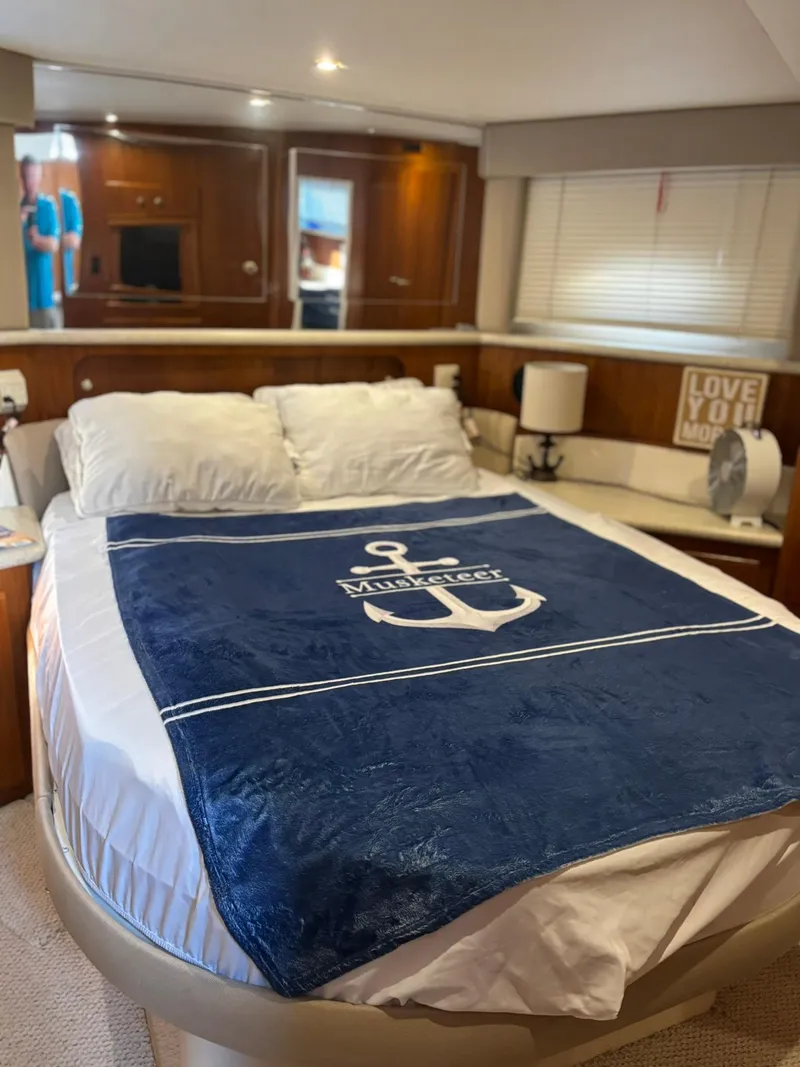 Slide: The Image of Cozy bedroom in 2000 Carver 406 Aft Cabin Motor Yacht with nautical-themed decor. - 34
