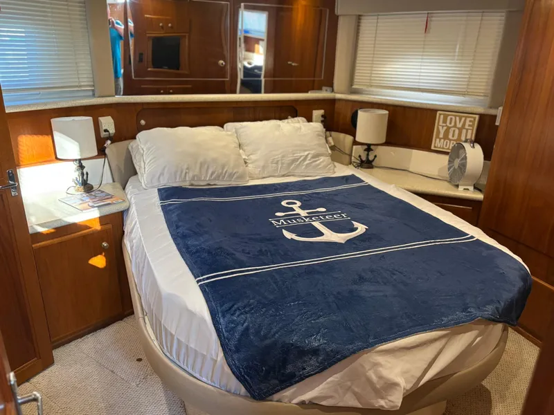 Slide: The Image of Cozy bedroom in 2000 Carver 406 Aft Cabin Motor Yacht with nautical-themed decor. - 35