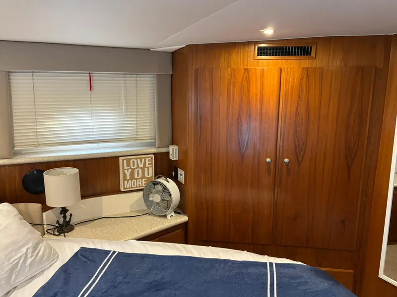 Slide: The Image of Cozy cabin interior of 2000 Carver 406 Aft Cabin Motor Yacht with wood paneling and decor. - 36
