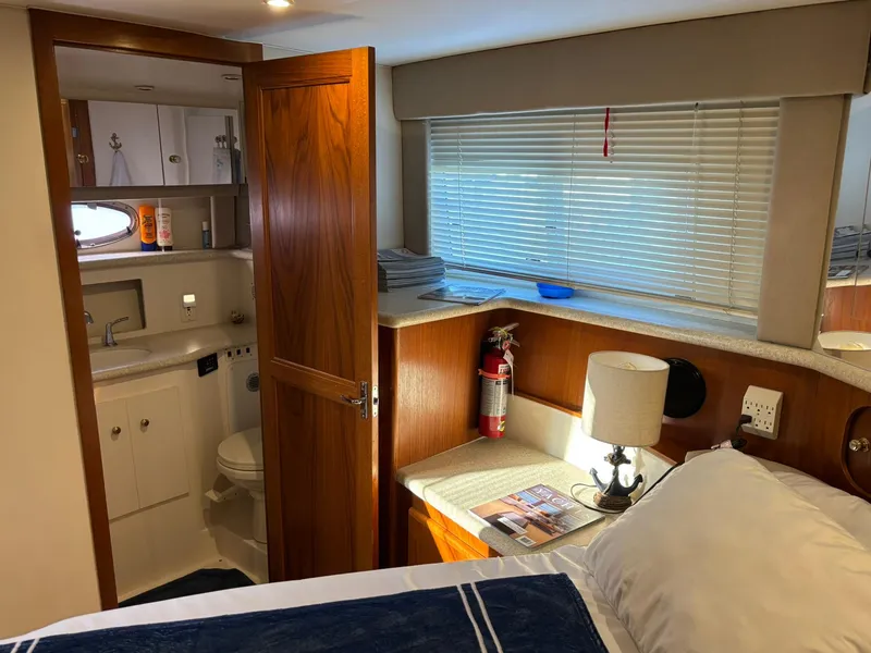 Slide: The Image of Interior of 2000 Carver 406 Aft Cabin Motor Yacht with cozy bedroom and bathroom. - 38
