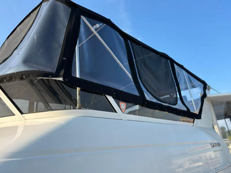 Slide: The Image of 2000 Carver 406 Aft Cabin Motor Yacht with black canopy against blue sky. - 4