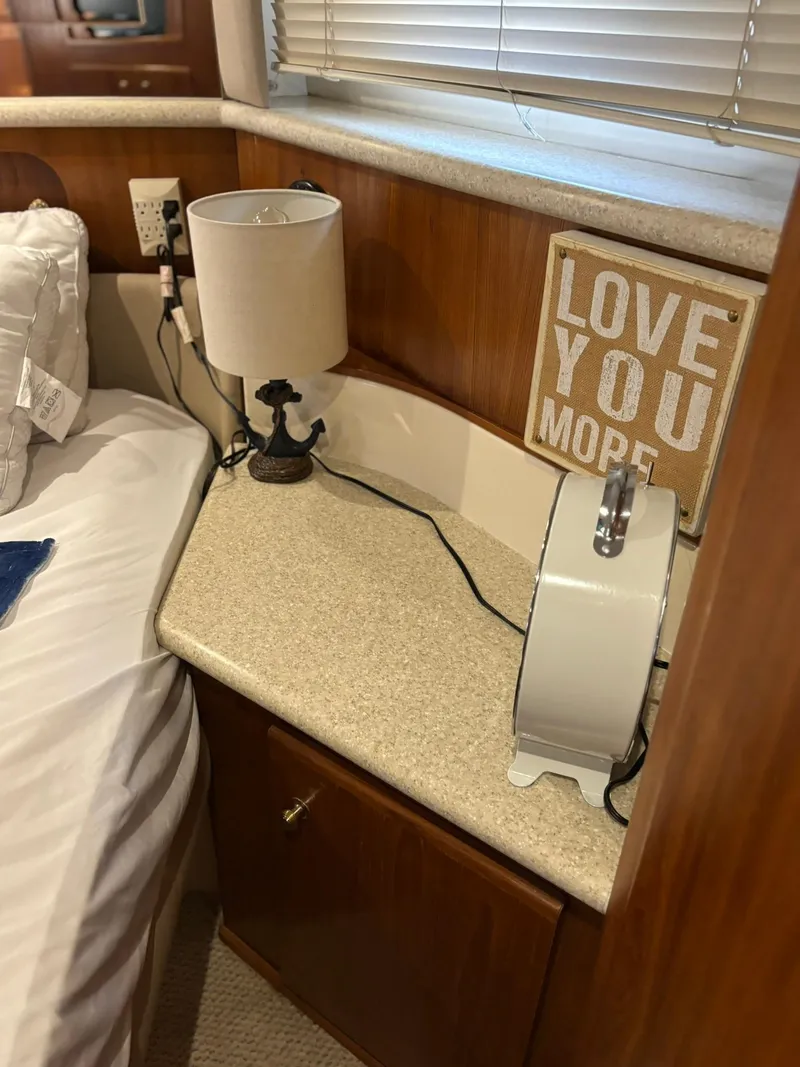 Slide: The Image of Cozy cabin interior of 2000 Carver 406 Yacht with lamp and "Love You More" sign. - 40