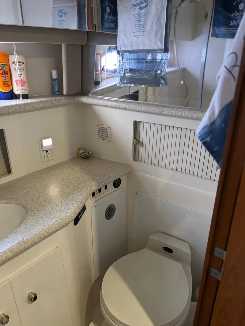 Slide: The Image of Bathroom interior of 2000 Carver 406 Aft Cabin Motor Yacht, featuring toilet and countertop. - 43