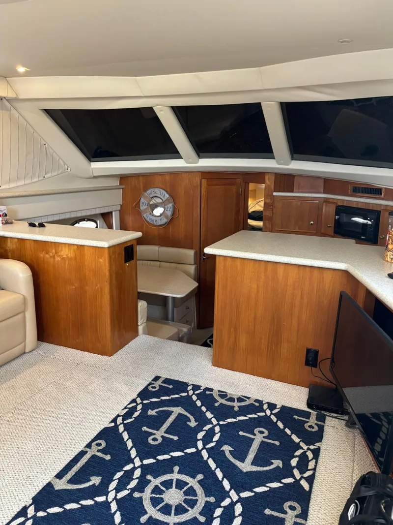 Slide: The Image of Interior of 2000 Carver 406 Aft Cabin Motor Yacht with nautical decor and wood finishes. - 44