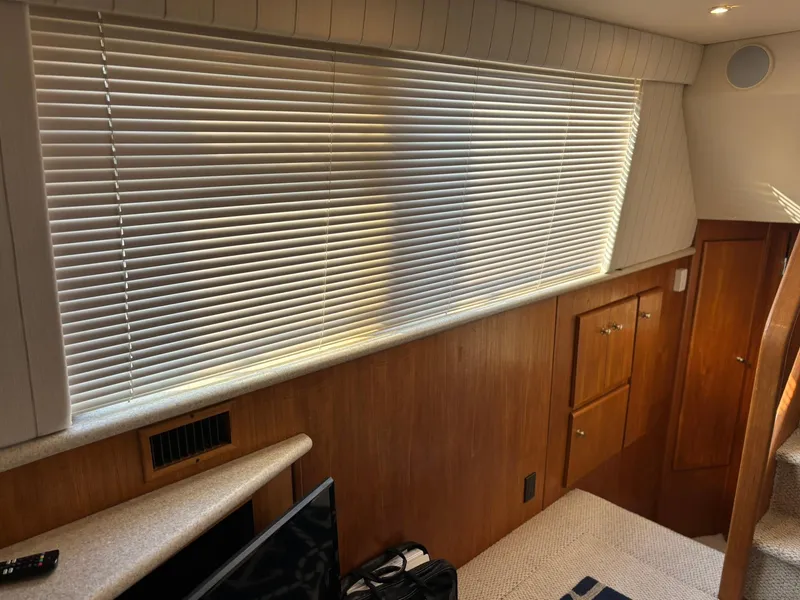 Slide: The Image of Interior of 2000 Carver 406 Aft Cabin Motor Yacht with blinds and wooden cabinetry. - 47