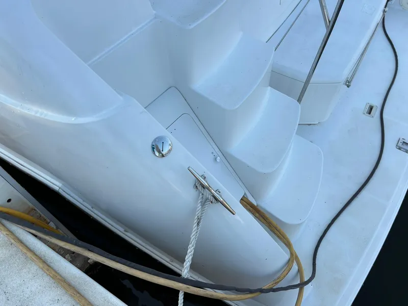 Slide: The Image of 2000 Carver 406 Aft Cabin Motor Yacht deck with steps and mooring lines. - 48