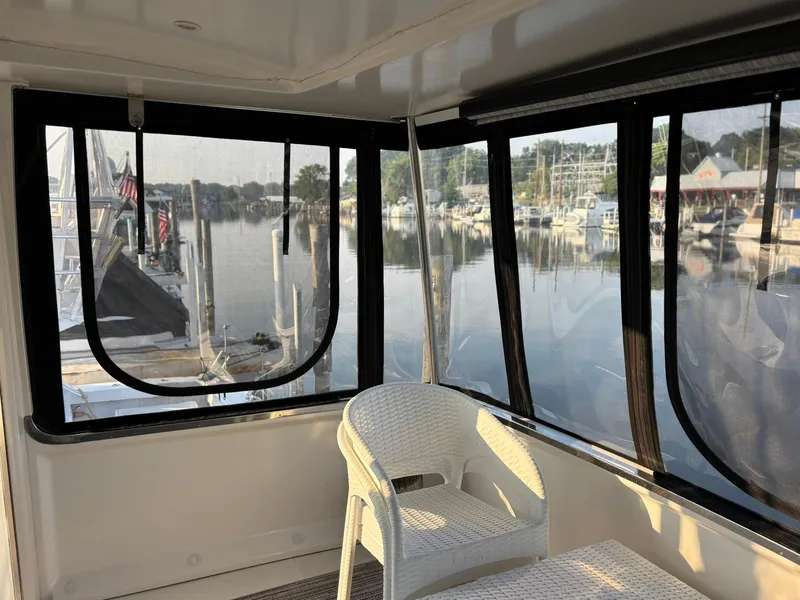 Slide: The Image of Interior view of 2000 Carver 406 Aft Cabin Motor Yacht with marina backdrop. - 6