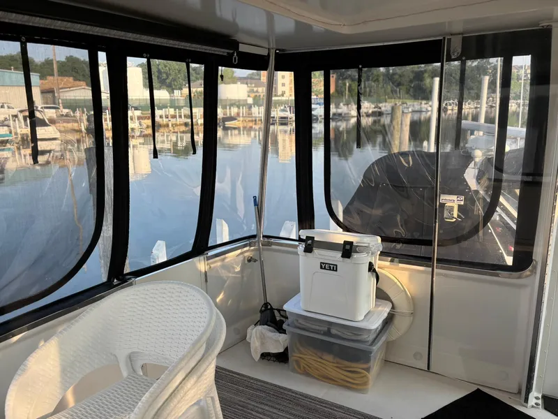 Slide: The Image of Interior view of 2000 Carver 406 Aft Cabin Motor Yacht with marina backdrop. - 8