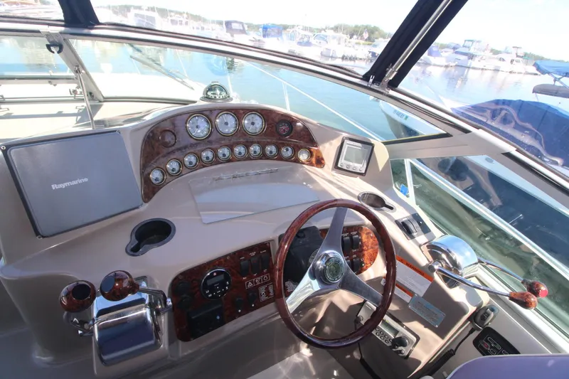Slide: The Image of 2004 Four Winns 348 Vista boat dashboard with steering wheel and navigation instruments. - 14