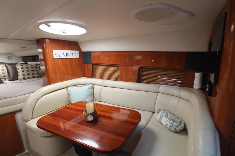 Slide: The Image of Luxurious interior of 2004 Four Winns 348 Vista yacht with elegant seating and wooden table. - 16