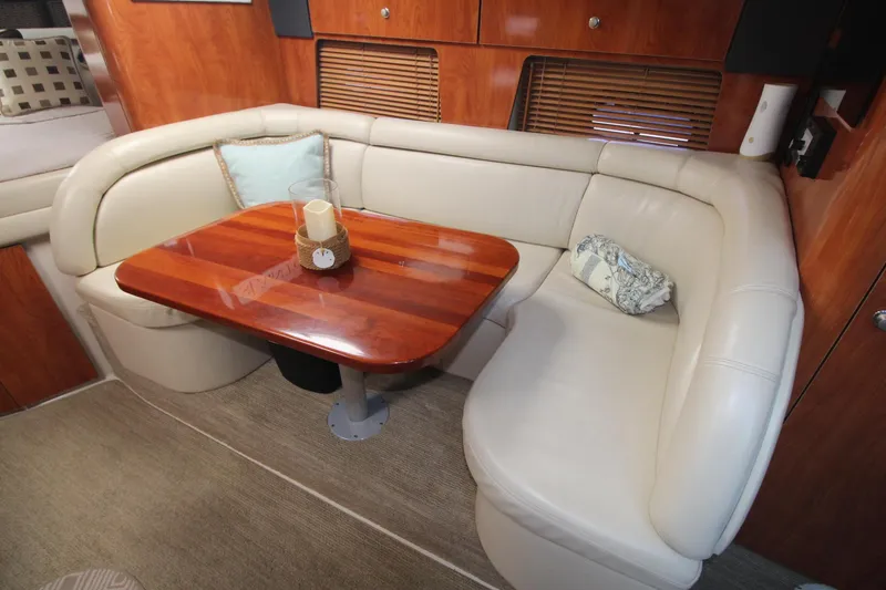 Slide: The Image of 2004 Four Winns 348 Vista interior with leather seating and wooden table. - 17