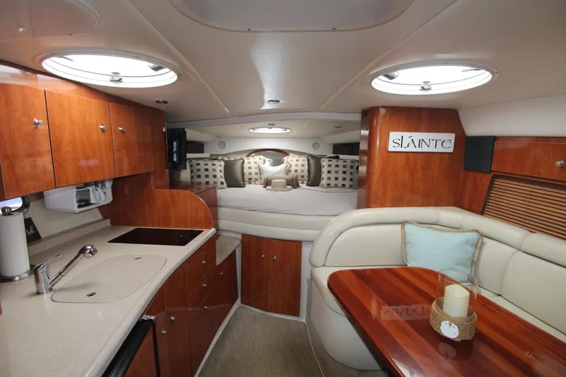 Slide: The Image of Luxurious interior of 2004 Four Winns 348 Vista yacht with elegant wood finishes and cozy seating. - 18