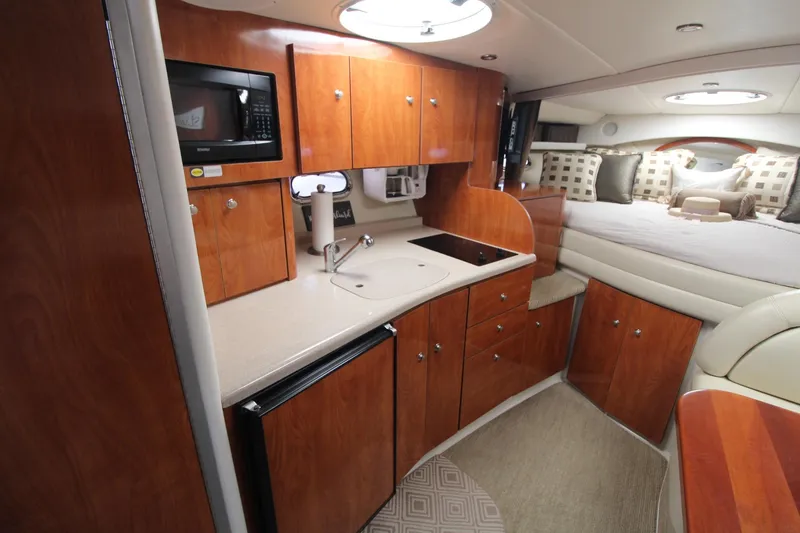 Slide: The Image of Interior of 2004 Four Winns 348 Vista yacht with kitchenette and cozy sleeping area. - 19