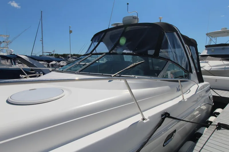 Slide: The Image of 2004 Four Winns 348 Vista yacht docked at marina under clear blue sky. - 2