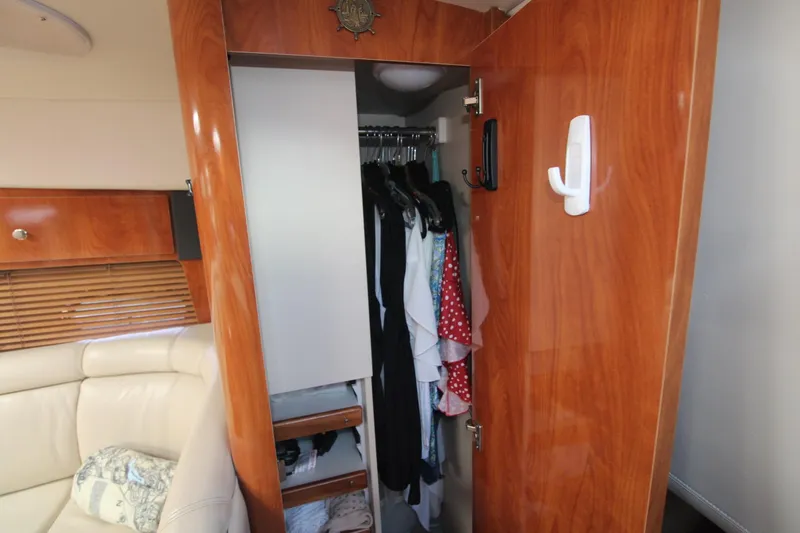 Slide: The Image of Interior of 2004 Four Winns 348 Vista showing wooden closet and seating area. - 28