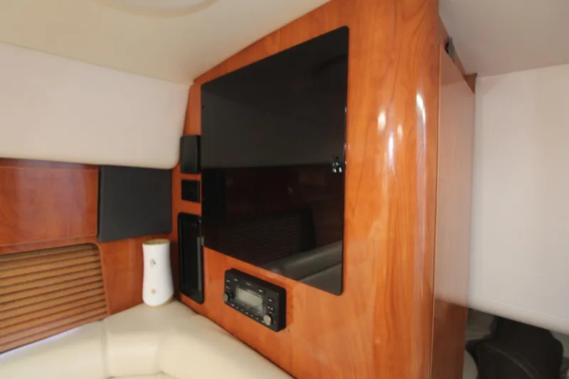 Slide: The Image of Interior of 2004 Four Winns 348 Vista yacht with wood paneling and entertainment system. - 29