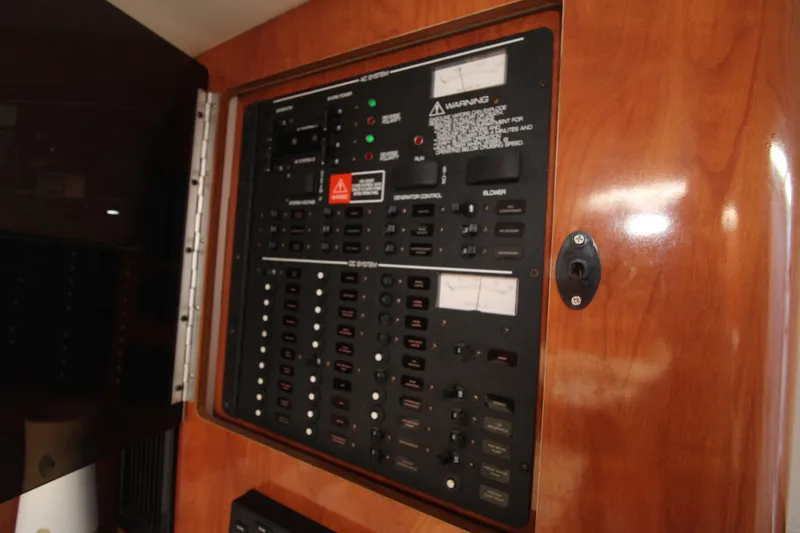Slide: The Image of Electrical panel on a 2004 Four Winns 348 Vista boat, featuring various switches and controls. - 30