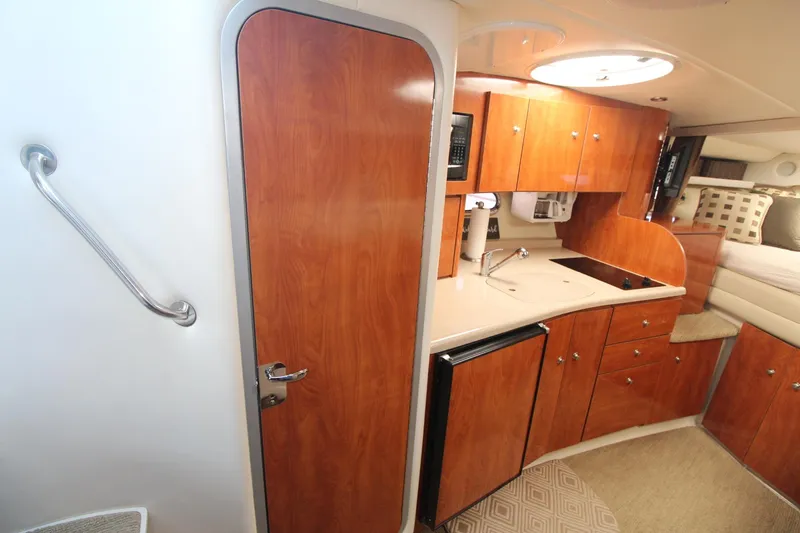 Slide: The Image of 2004 Four Winns 348 Vista yacht interior with kitchenette and wood cabinetry. - 31