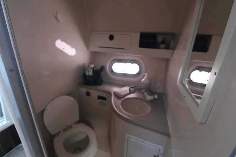Slide: The Image of 2004 Four Winns 348 Vista boat bathroom with sink, toilet, and mirror. - 33
