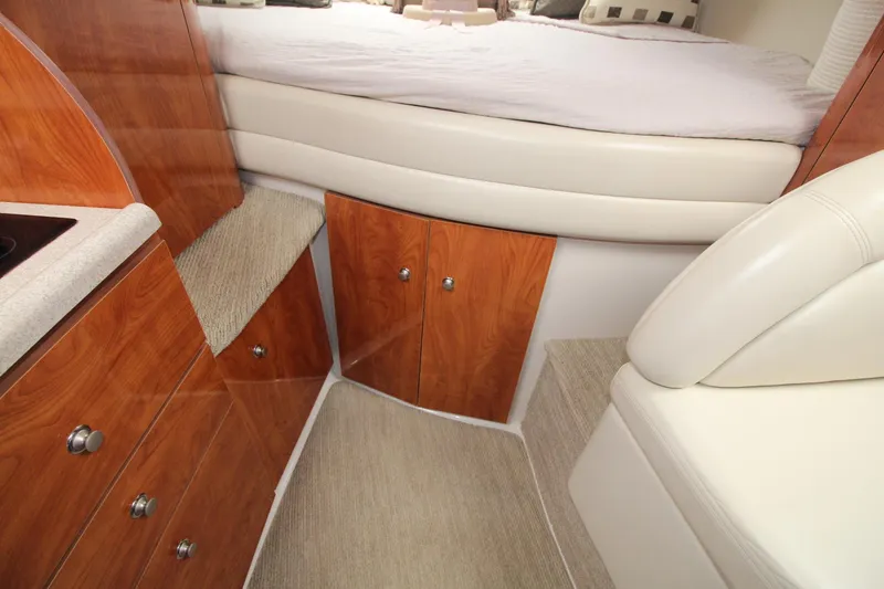 Slide: The Image of Interior of 2004 Four Winns 348 Vista boat with wood cabinetry and cushioned seating. - 36