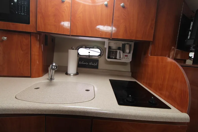 Slide: The Image of 2004 Four Winns 348 Vista yacht kitchen with wood cabinets and modern appliances. - 38