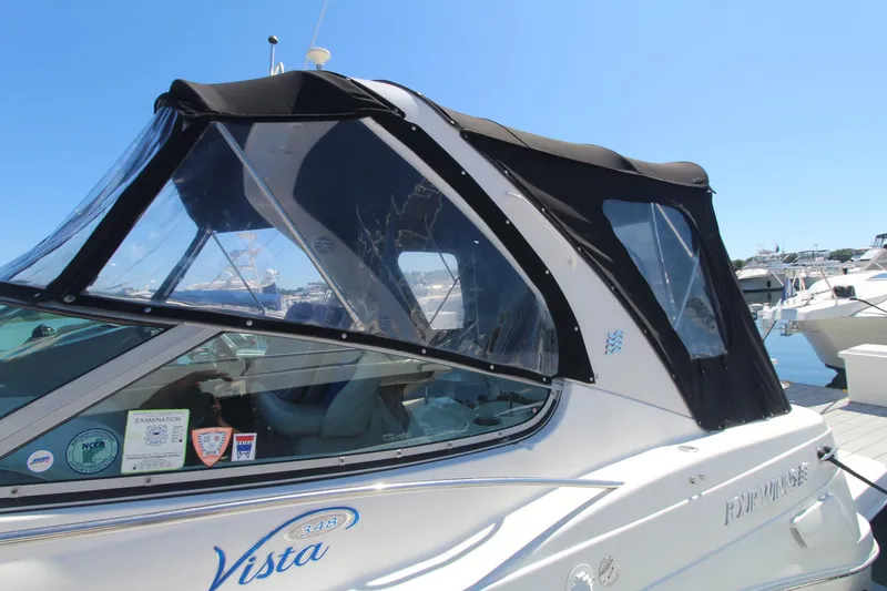 Slide: The Image of 2004 Four Winns 348 Vista boat with black canopy docked at marina. - 4