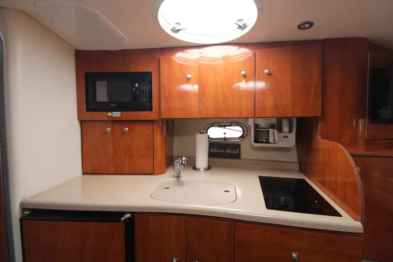 Slide: The Image of 2004 Four Winns 348 Vista yacht kitchen with microwave, sink, and stove. - 40