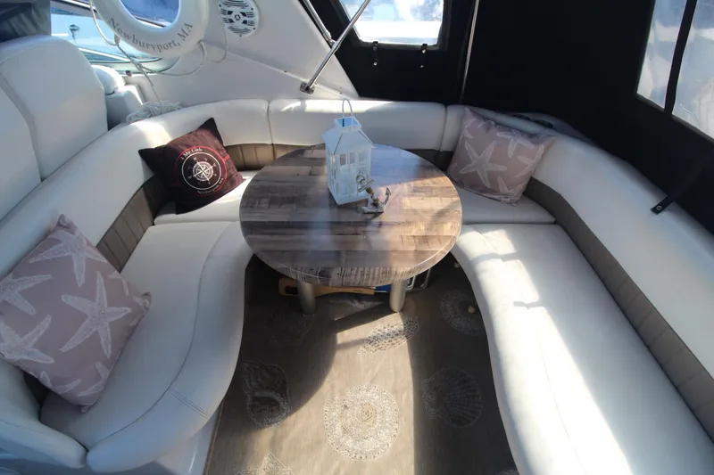 Slide: The Image of Luxurious 2004 Four Winns 348 Vista yacht interior with cozy seating and decorative pillows. - 6