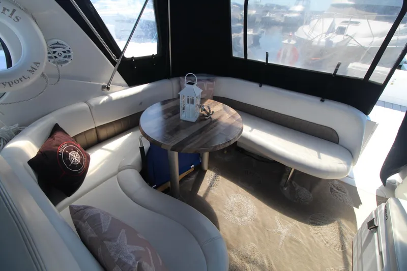 Slide: The Image of Interior of 2004 Four Winns 348 Vista yacht with cozy seating and table. - 9