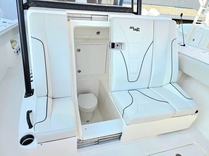 Slide: The Image of 2023 SeaVee 37 Z boat interior with white seating and built-in toilet. - 10