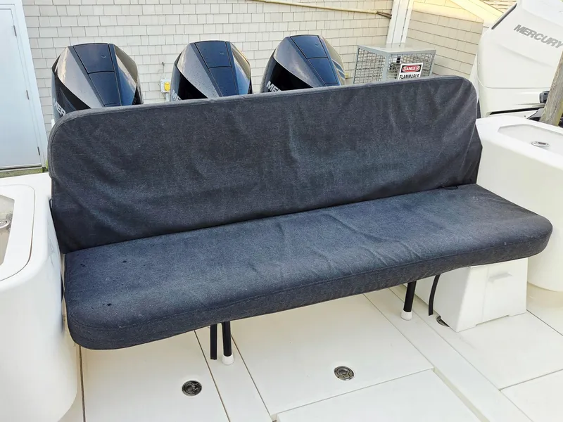 Slide: The Image of 2023 SeaVee 37 Z boat with covered bench seat and Mercury outboard engines. - 12