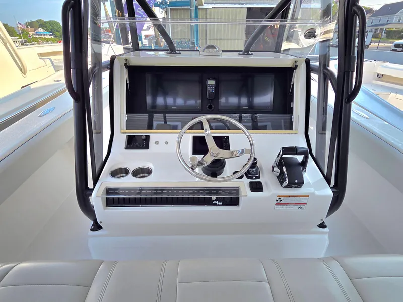 Slide: The Image of 2023 SeaVee 37 Z boat helm with steering wheel and control panel. - 13