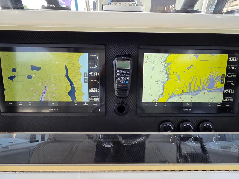 Slide: The Image of 2023 SeaVee 37 Z boat dashboard with dual Garmin navigation screens and communication device. - 15