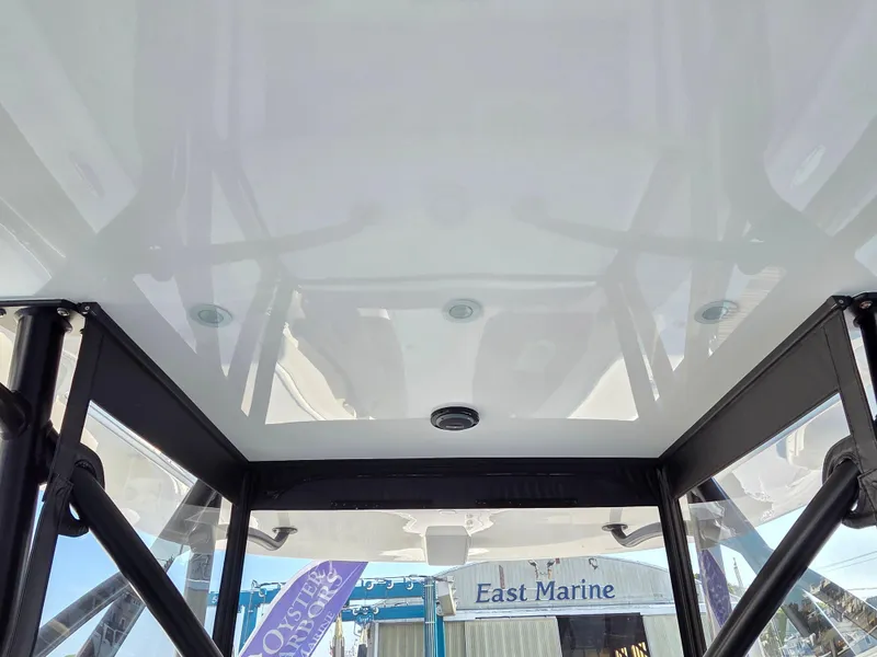 Slide: The Image of 2023 SeaVee 37 Z boat interior with sturdy frame and clear roof, docked at East Marine. - 19