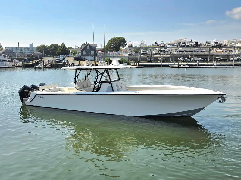 Slide: The Image of 2023 SeaVee 37 Z boat docked in a marina under clear skies. - 2