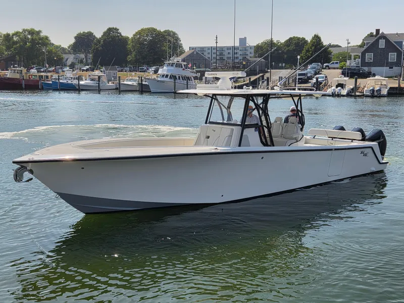Slide: The Image of 2023 SeaVee 37 Z boat docked in a marina, surrounded by other vessels. - 29