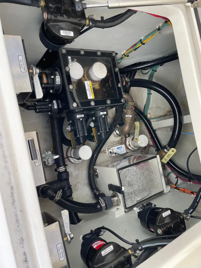 Slide: The Image of Engine compartment of a 2023 SeaVee 37 Z boat, showcasing mechanical components and wiring. - 30