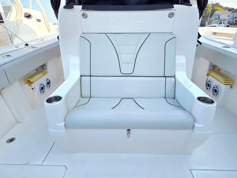 Slide: The Image of 2023 SeaVee 37 Z boat interior with white cushioned seating and cup holders. - 8