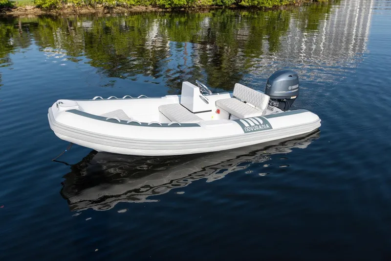 Slide: The Image of 2026 Novurania DL 400 boat on calm water, featuring sleek design and Yamaha outboard motor. - 13