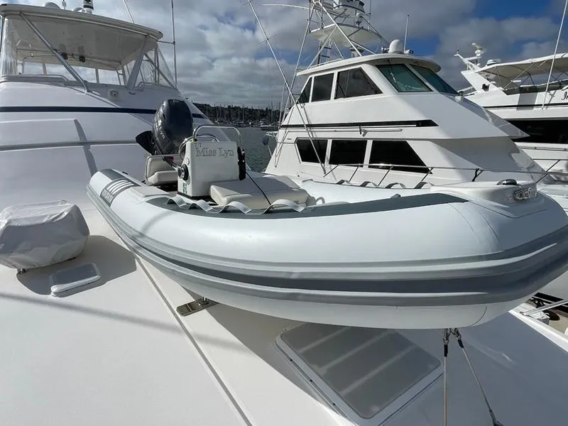 Slide: The Image of 2026 Novurania DL 400 inflatable boat on yacht deck, marina background. - 6