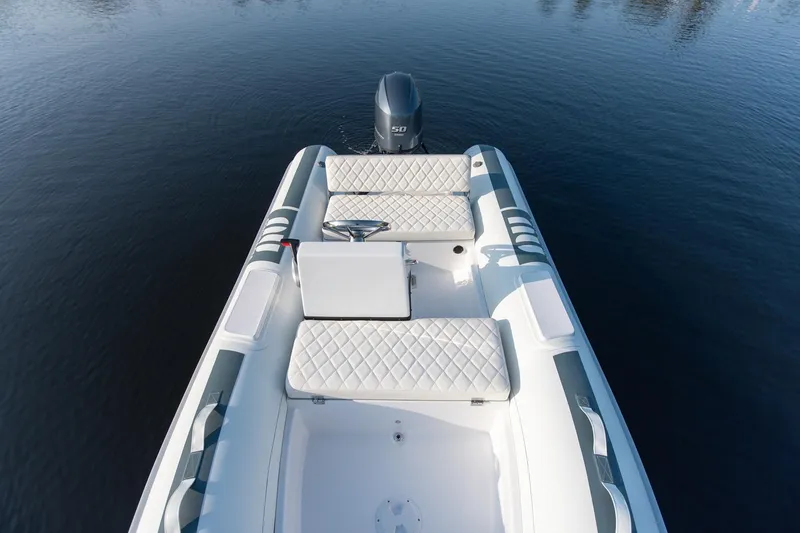 Slide: The Image of Novurania DL 400 boat, 2026 model, with white seating on calm water. - 8