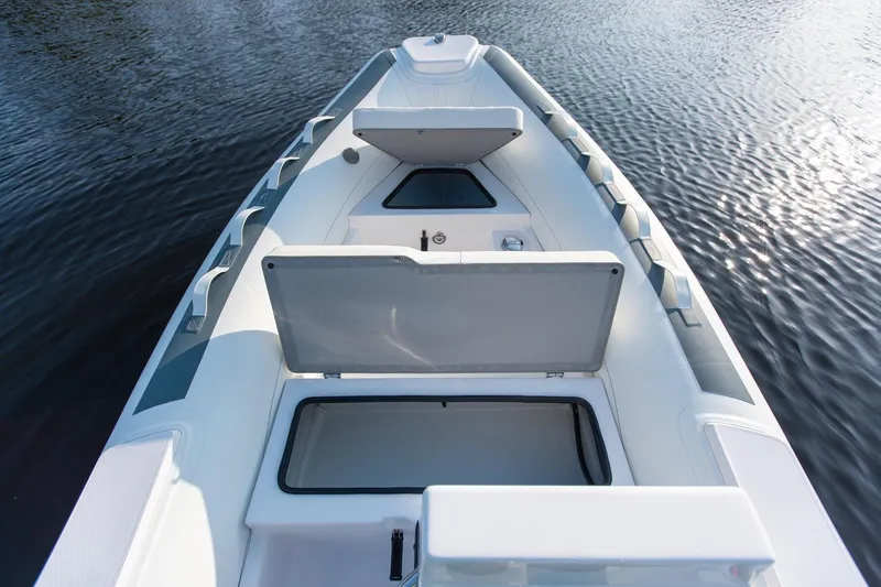 Slide: The Image of 2026 Novurania DL 400 boat interior with open storage compartments on calm water. - 9