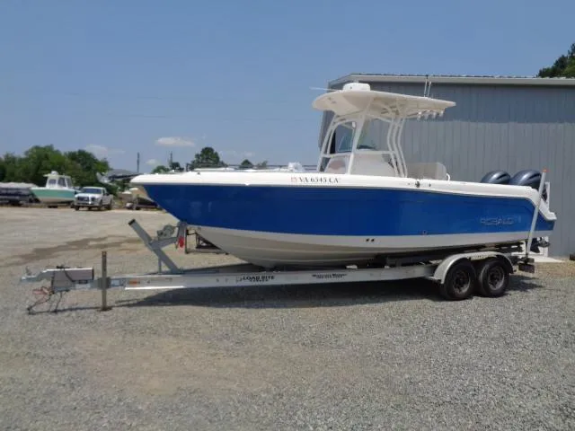 Slide: The Image of 2017 Robalo R260 Center Console boat on trailer in outdoor setting. - 0