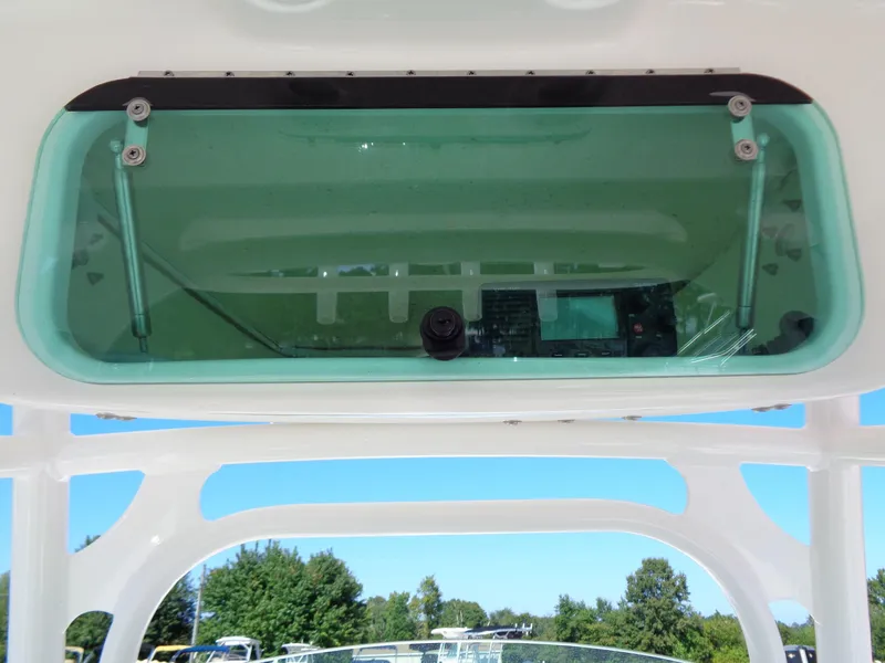 Slide: The Image of 2017 Robalo R260 Center Console boat with overhead electronics compartment. - 10