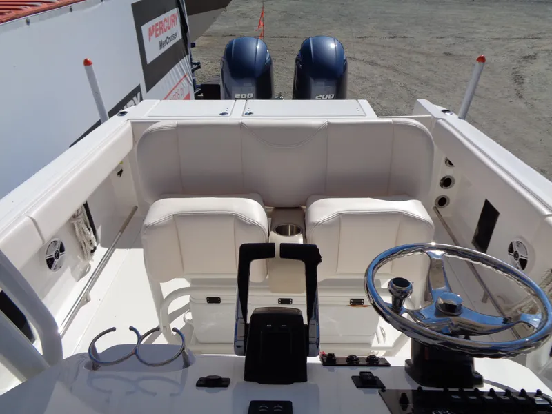 Slide: The Image of 2017 Robalo R260 Center Console boat interior with dual seats and steering wheel. - 11