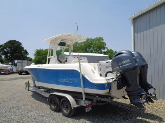 Slide: The Image of 2017 Robalo R260 Center Console boat with dual Yamaha engines on a trailer. - 2